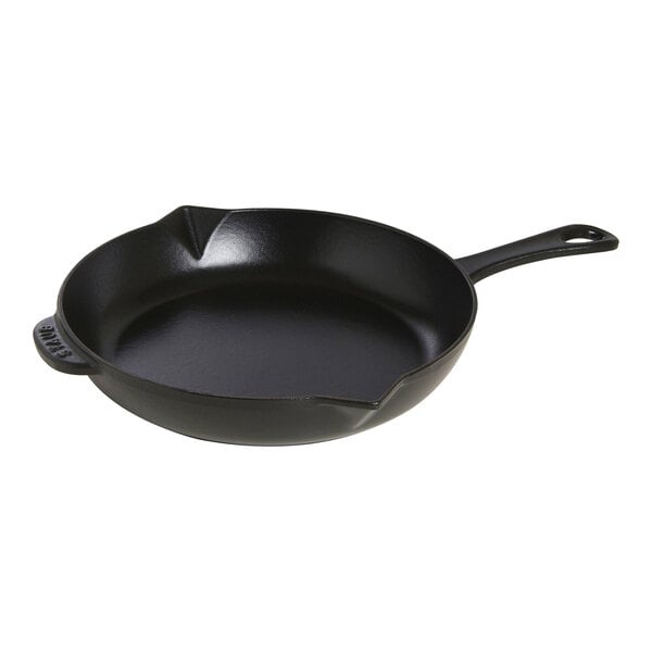 A black Staub enameled cast iron skillet with a handle.