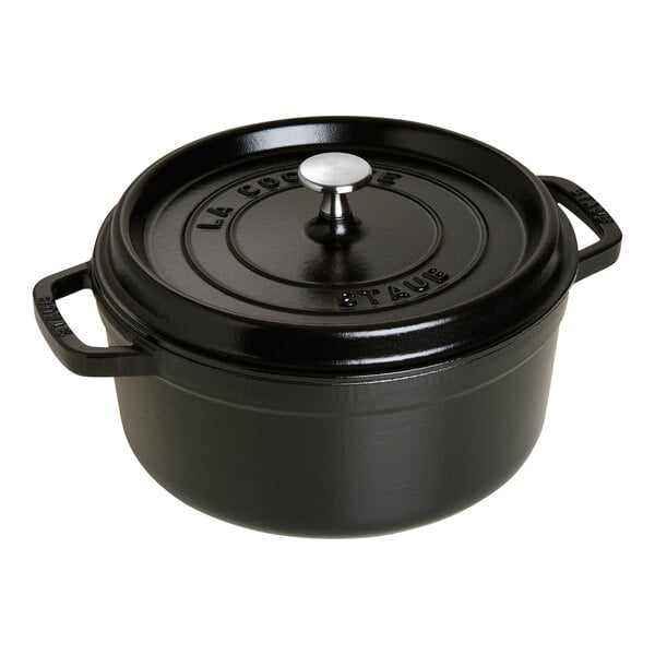 A black Staub enameled cast iron Dutch oven with a lid.