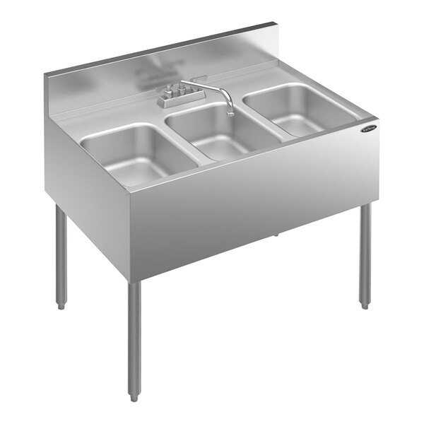 A Krowne stainless steel underbar sink with three bowls and a faucet.