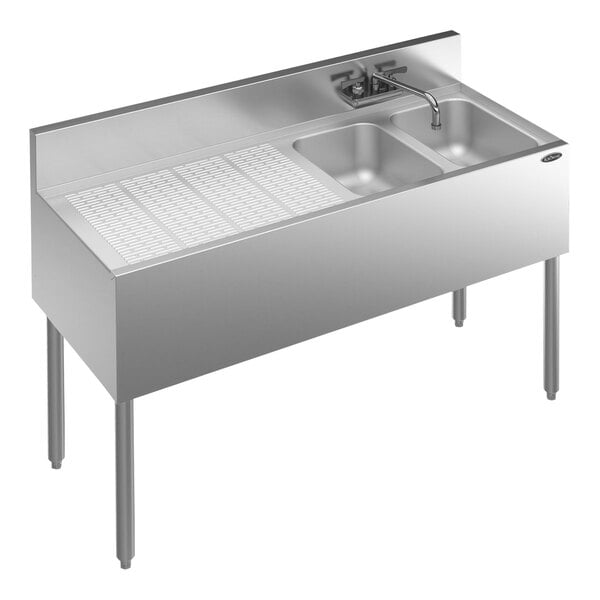 A stainless steel Krowne Royal Series underbar sink with two bowls, a faucet, and a left drainboard.