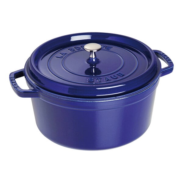 A dark blue Staub enameled cast iron pot with a lid.