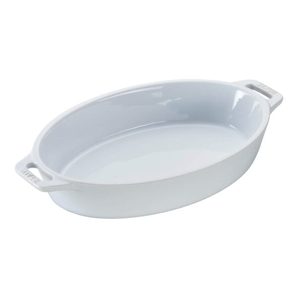 A white oval baking dish with handles.