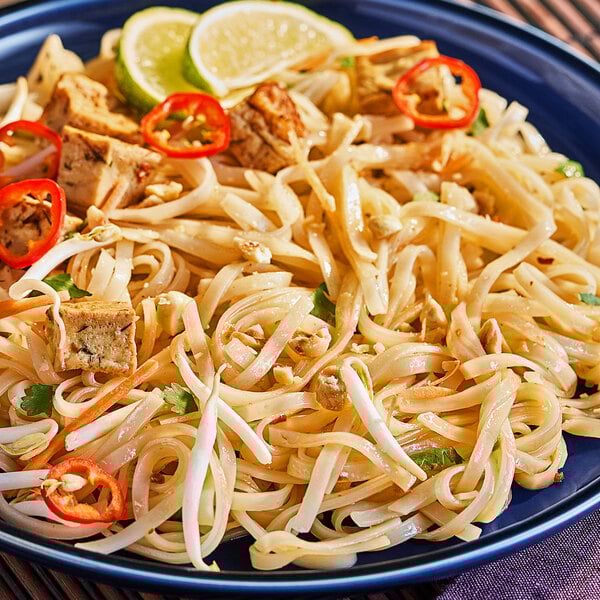 A plate of Lotus Foods Pad Thai rice noodles with tofu and lime.