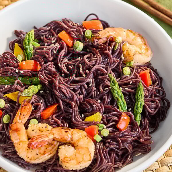 A bowl of Lotus Foods Organic Forbidden Rice Ramen with shrimp and vegetables.