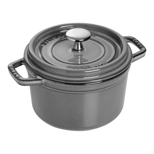 A Staub graphite gray enameled cast iron Dutch oven with a lid and handle.