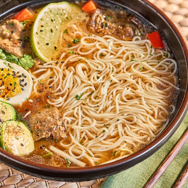 A bowl of soup with Lotus Foods Traditional Pho Rice Noodles and vegetables.