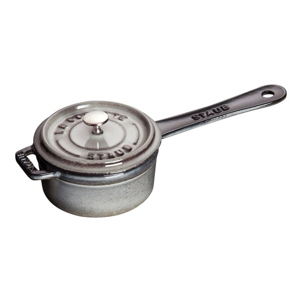 A Staub graphite gray enameled cast iron mini saucepan with lid and handle.