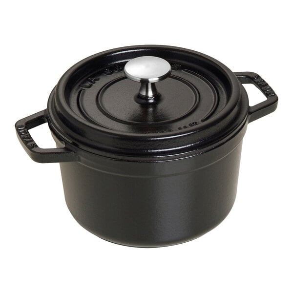 A black Staub enameled cast iron dutch oven with a lid.