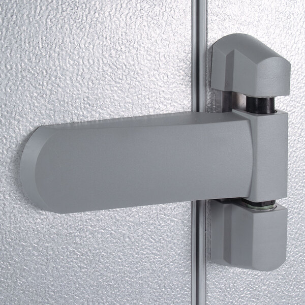 The grey hinge of a Kolpak walk-in cooler door.