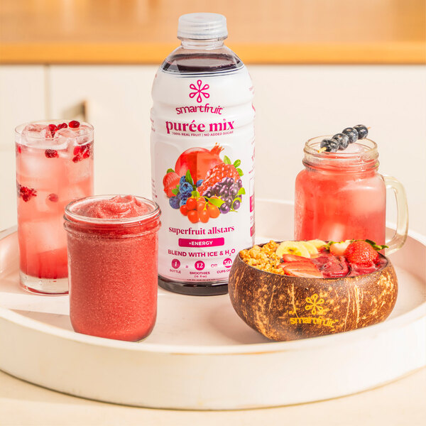 a bowl of fruit and a smoothie