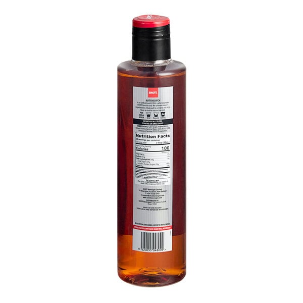 A close-up of a SHOTT Butterscotch Flavoring Syrup bottle with a red lid.