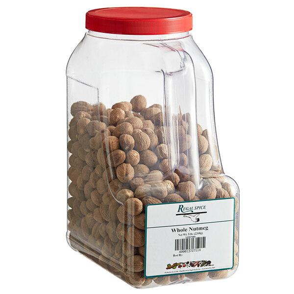 A plastic container of whole nutmeg with nuts inside.