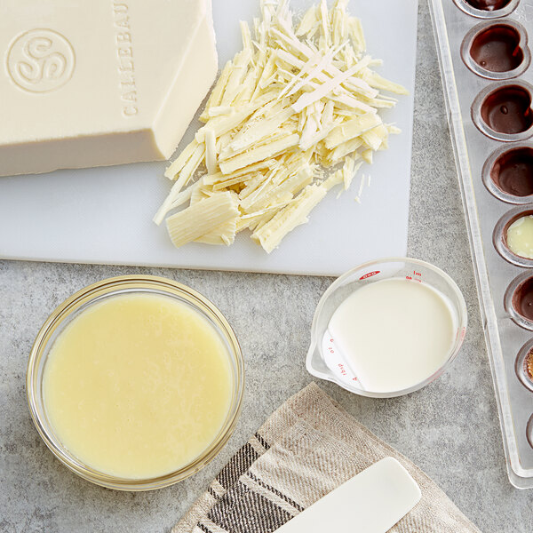 A block of Callebaut white chocolate on a counter in a professional kitchen.