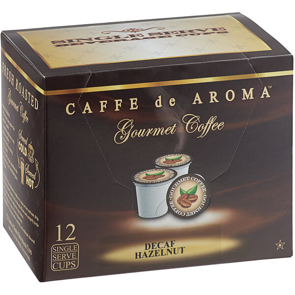 A box of 12 Caffe de Aroma decaf hazelnut coffee single serve cups on a counter.