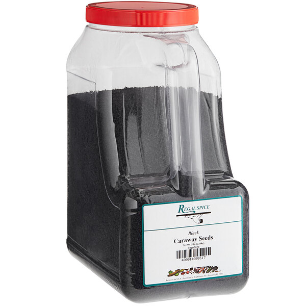 A white container of black Regal caraway seeds with a red lid.