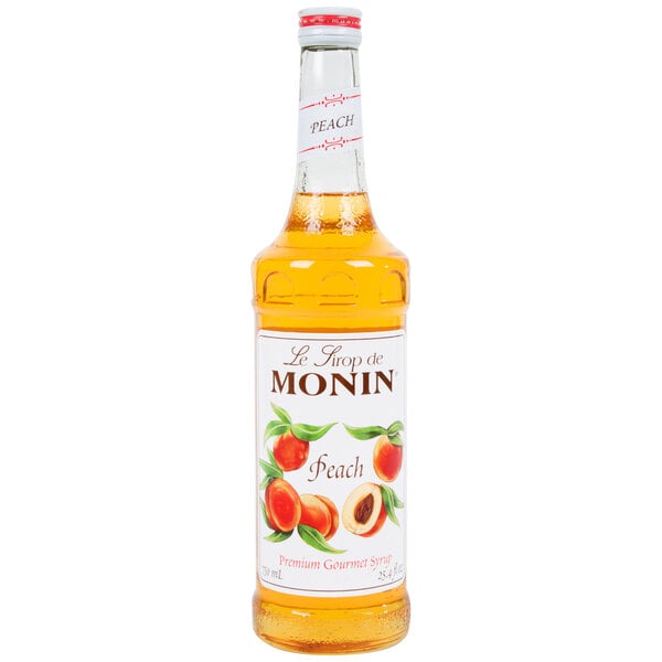 A Monin Peach Syrup 750 mL bottle.