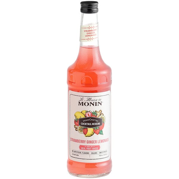 A Monin HomeCrafted Strawberry Ginger Lemonade Cocktail Mix bottle filled with red liquid.
