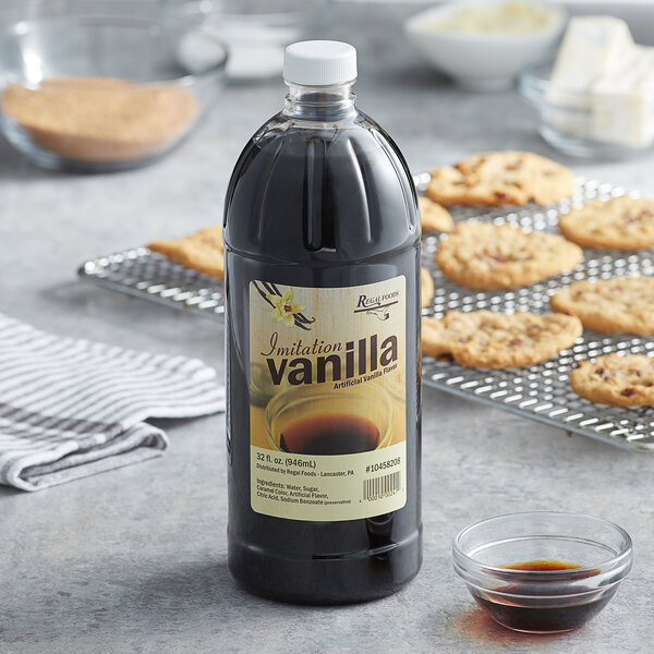 A bottle of Regal Imitation Vanilla next to a cookie tray.