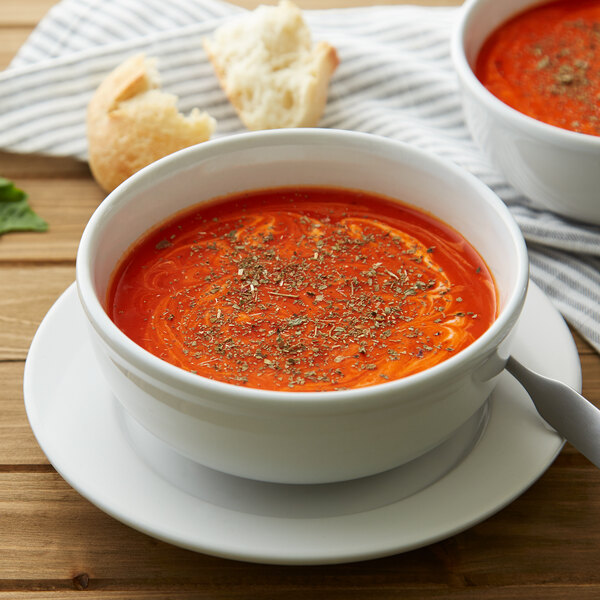 A bowl of soup with Regal Fancy Basil Leaves on a table.