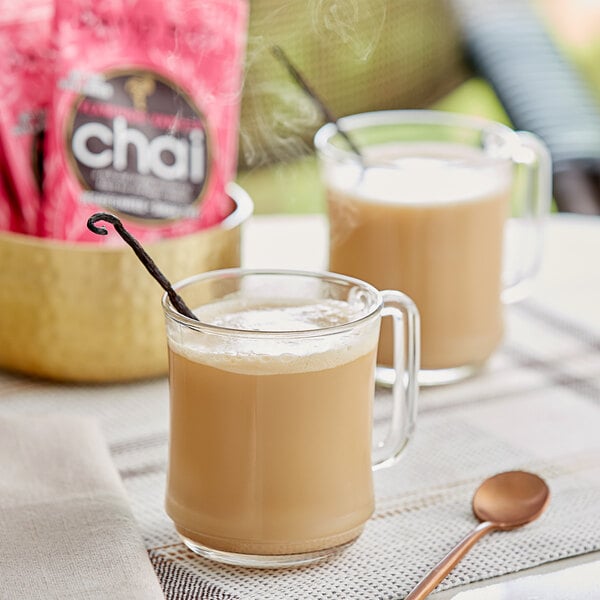 Two glass mugs of David Rio Flamingo Vanilla Decaf Sugar-Free Chai Tea Latte on a table.