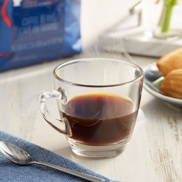 A glass of Lavazza Gran Espresso coffee on a table.