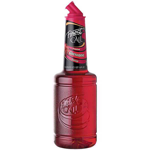 A close up of a bottle of Finest Call Premium Grenadine syrup with a red lid.
