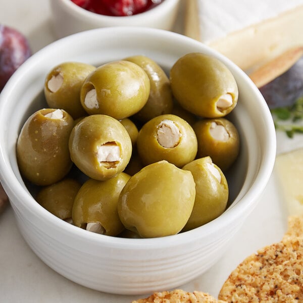 A white bowl filled with green Belosa blue cheese stuffed olives.