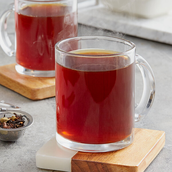 Two glass mugs of Davidson's Organic Classic Chai tea on a wooden tray.