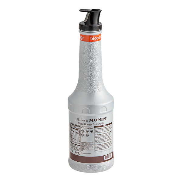 A close up of a Monin white bottle of blood orange fruit puree with a black lid.