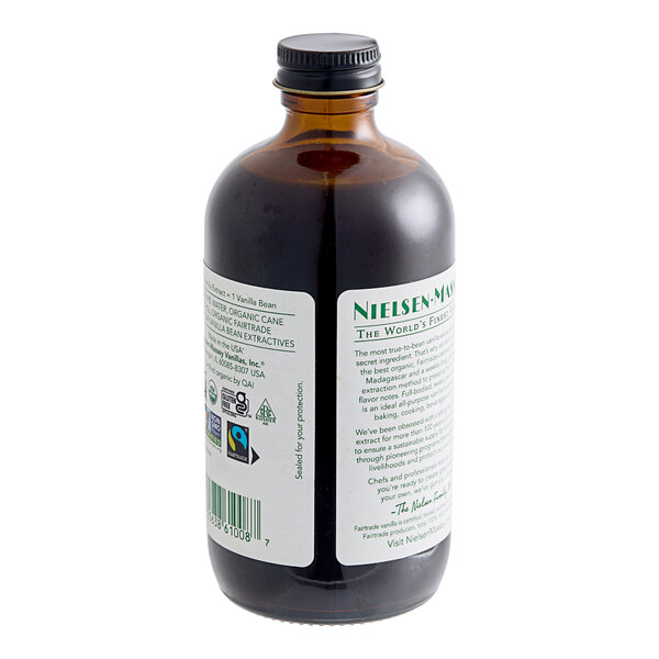 A close-up of a bottle of Nielsen-Massey Organic Madagascar Bourbon Vanilla Extract with a label.