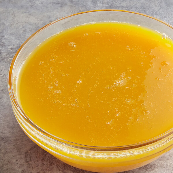 A bowl of passion fruit puree on a counter in a juice bar.