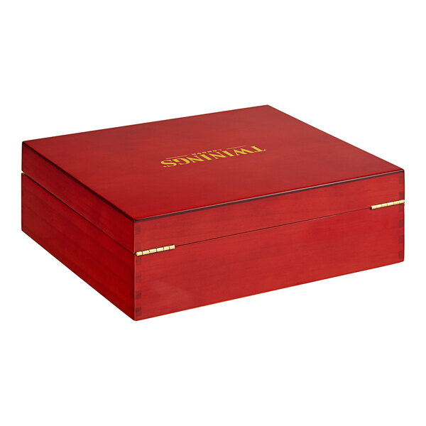 A red Twinings wooden tea chest with gold lettering on it.