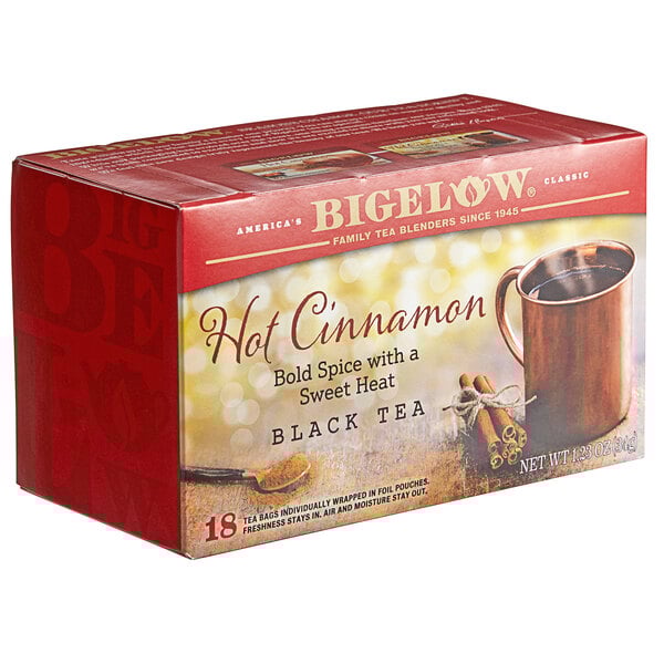 A box of Bigelow Hot Cinnamon Tea Bags on a counter with a picture of a mug and cinnamon sticks.