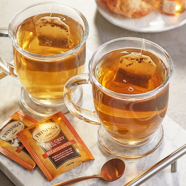 A tray with two glass mugs of Twinings Earl Grey Decaffeinated Tea and a couple of tea bags.