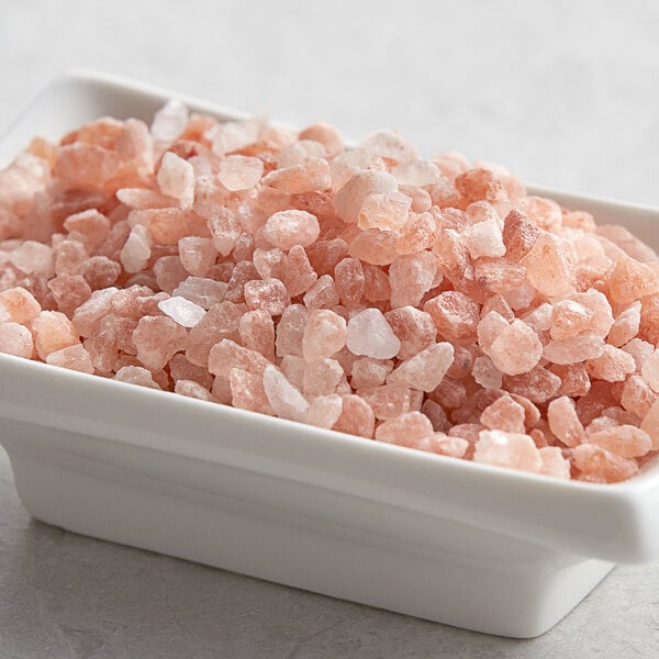 A small bowl filled with Regal Extra Coarse Grain Pink Himalayan Salt.