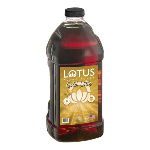 A large clear plastic bottle with a black cap containing a dark amber liquid and a gold label on the front.