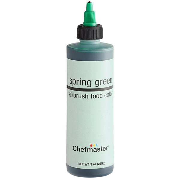 A close-up of a Chefmaster Spring Green airbrush food color bottle.