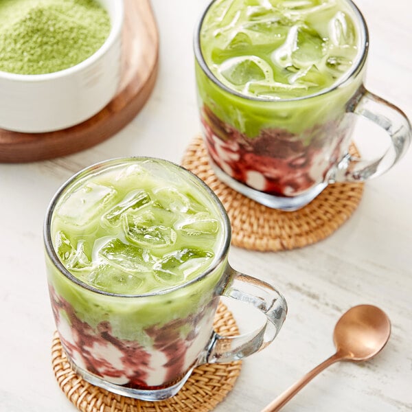 A glass cup with ice and a green liquid made with Jade Leaf Organic Sweetened Matcha Latte Mix.
