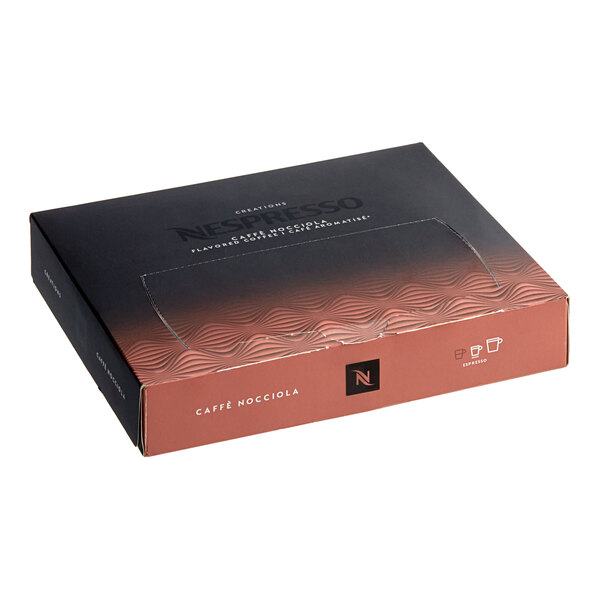A box of Nespresso Professional Caffe Nocciola coffee capsules with a black and white design and a logo on the table.