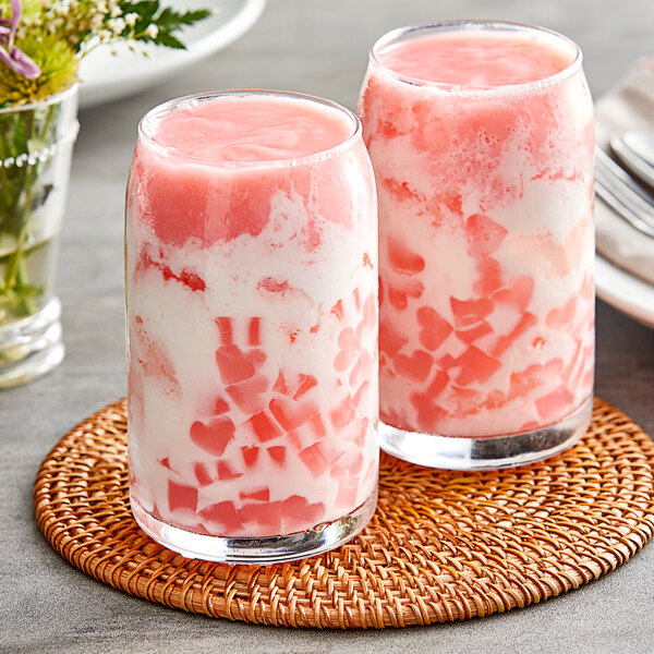 Two glasses with pink and white Fanale strawberry pudding powder mix in them.