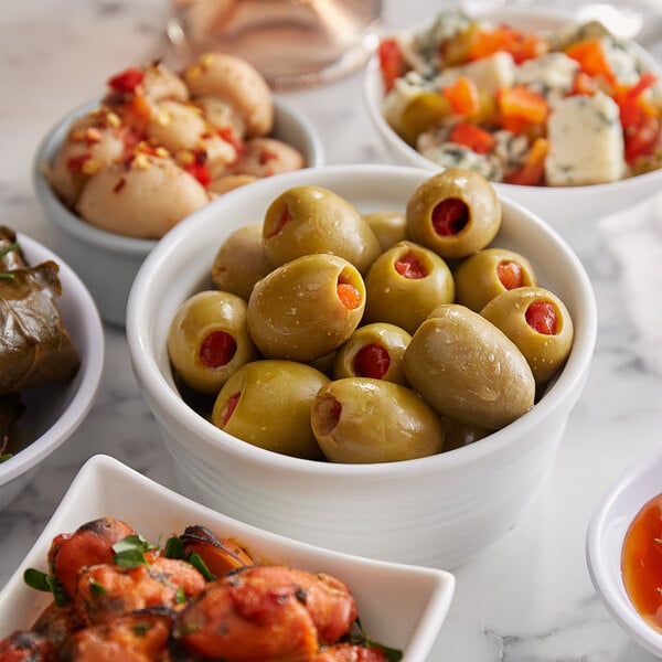 A white bowl filled with green Belosa Bloody Mary flavored stuffed olives.