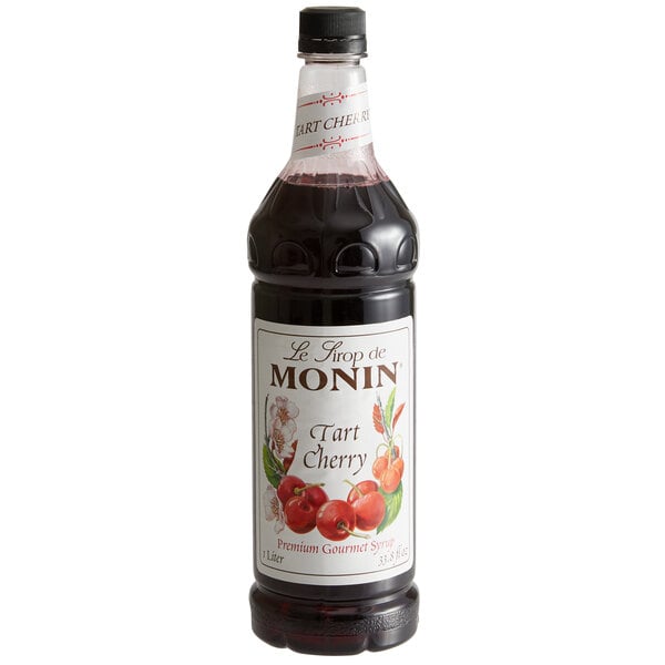 A close up of a Monin Premium Tart Cherry flavoring syrup bottle.