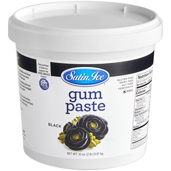 A white tub of black Satin Ice gum paste.