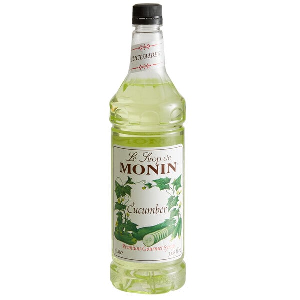 A white Monin bottle of cucumber liquid syrup with a label.