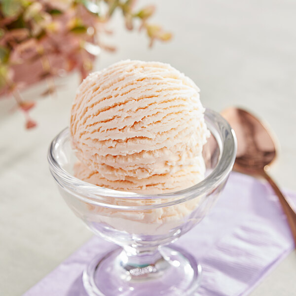 A bowl of I. Rice Rum hard serve ice cream with a spoon in it.