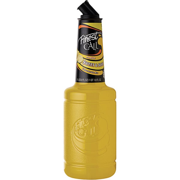 A yellow bottle of Finest Call sweet and sour mix concentrate with a lid.