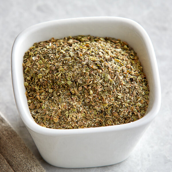 A bowl of Regal Pizza Seasoning on a table.