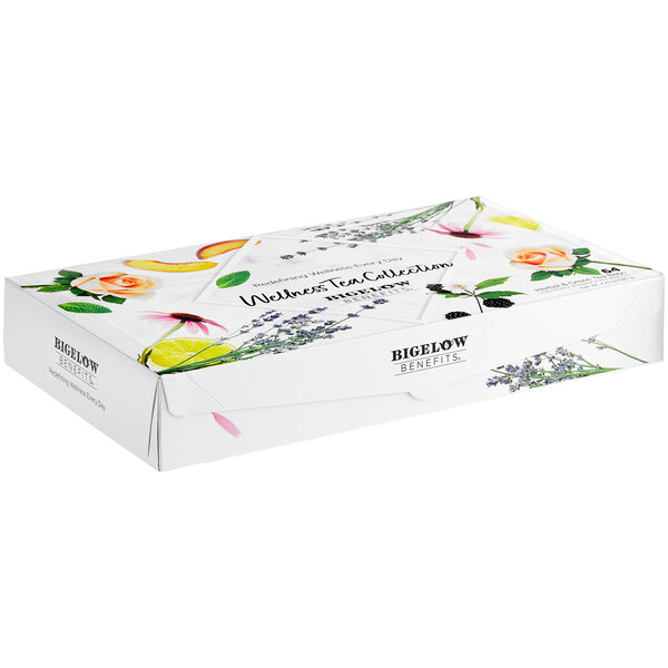 A white Bigelow tea box with flowers and leaves on it.