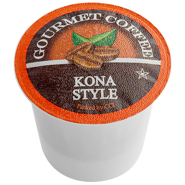 A white container of Caffe de Aroma Kona style coffee single serve cups with an orange and black label.