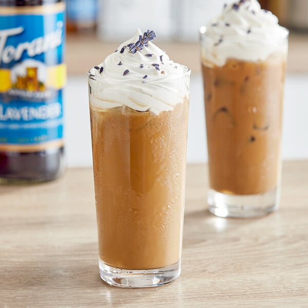 Two glasses of iced coffee with whipped cream and Torani Sugar-Free Lavender syrup.